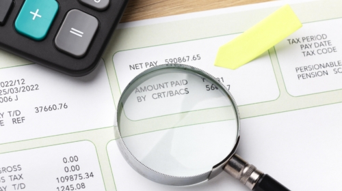 Payroll still life with magnifying glass