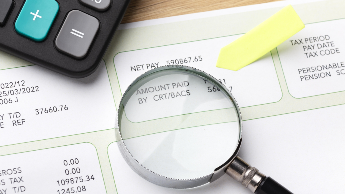 Payroll still life with magnifying glass
